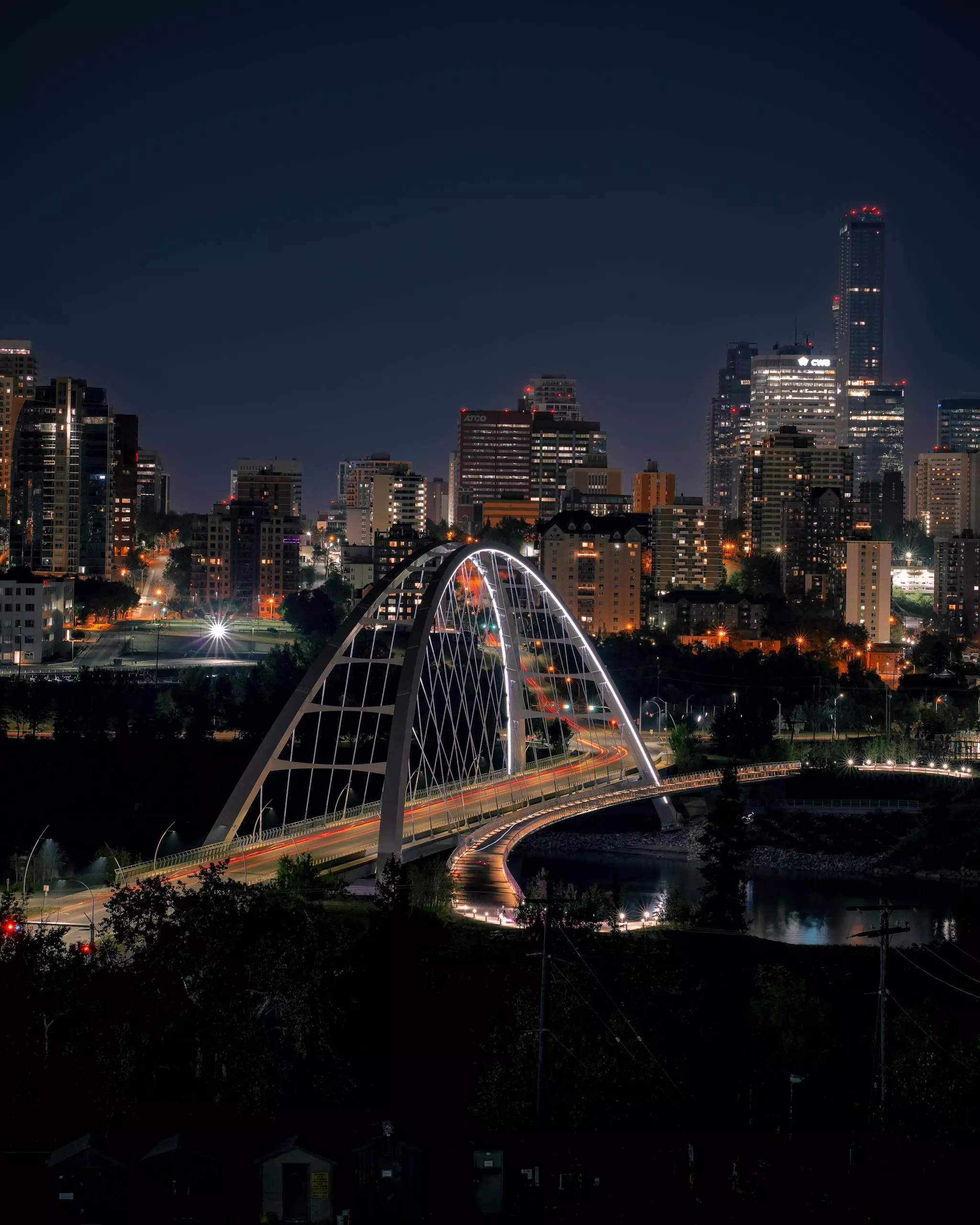 Night view of the Walterdale Bridge with Edmonton's skyline, beautifully illuminated. A stunning urban landmark.