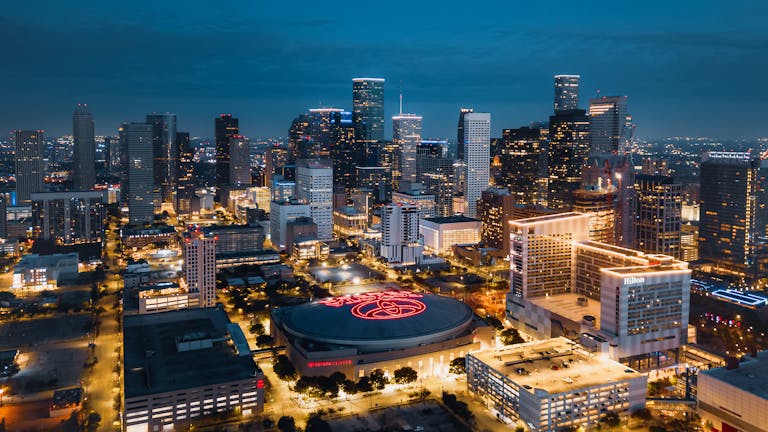 Stunning aerial panorama of Houston's illuminated skyline at night showcasing modern skyscrapers.