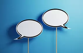white chat bubbles with wooden sticks on blue background